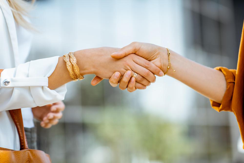 businesswomen-shaking-hands-outdoors-2022-01-18-23-53-57-utc