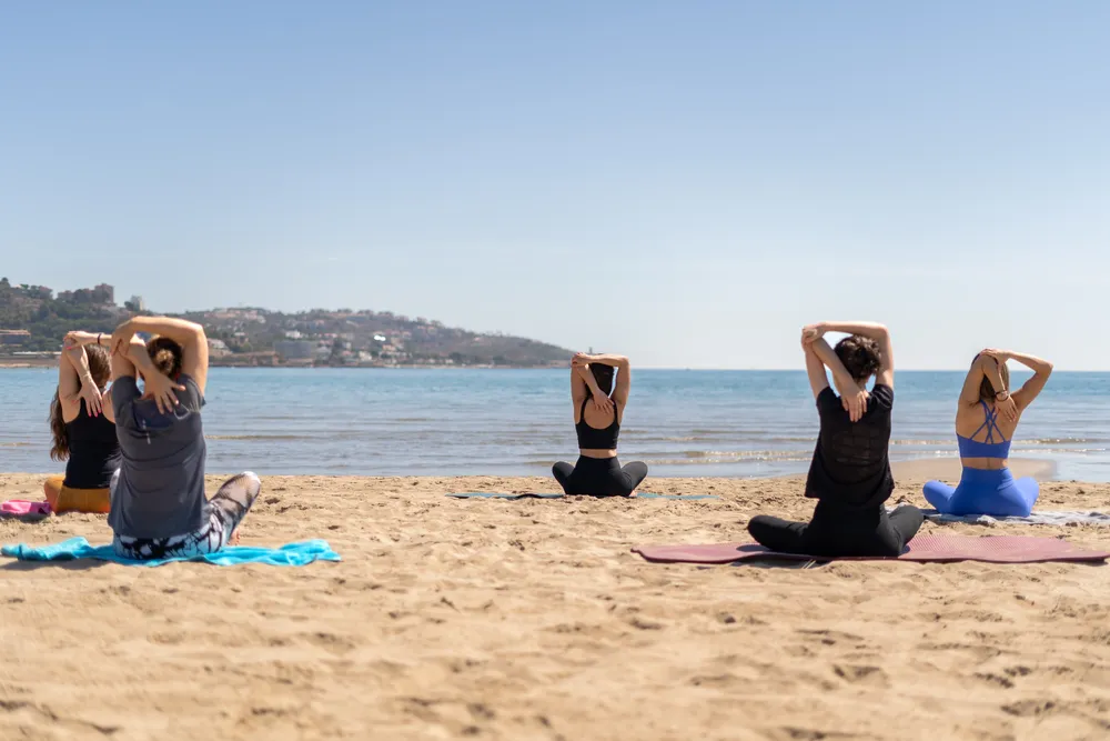 group-doing-pilates-on-the-beach-2025-06-08-23-19-26-utc