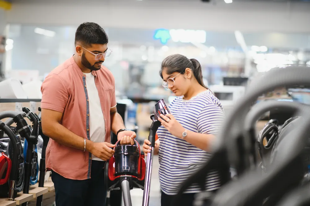 a-young-indian-couple-buys-a-vacuum-cleaner-at-an-2025-03-16-01-22-47-utc