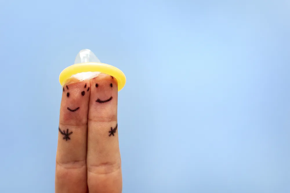 fingers-under-condom-safe-sex-concept-prevention-2025-02-02-23-42-42-utc