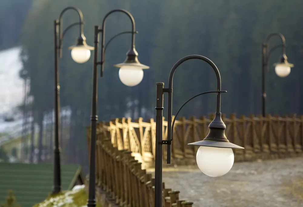 street-light-lamps-and-wooden-fence-on-rural-stree-2023-11-27-05-20-04-utc