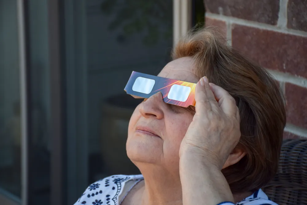 closeup-older-woman-watching-solar-eclipse-using-s-2025-03-12-21-43-09-utc